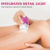 A hand holds a pink electric hair removal epilator device against bare skin.