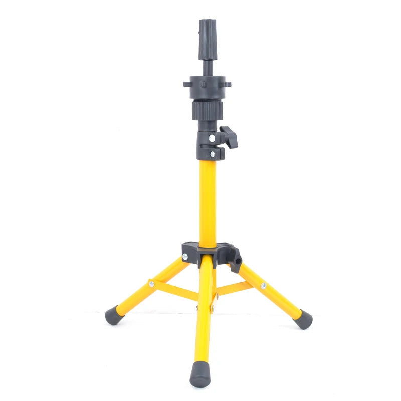 A yellow adjustable wig stand tripod with a black adjustable arm and stable base.