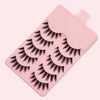 A pink plastic tray holding five pairs of dramatic manga style false eyelashes.