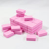 A stack of pink multi-sided nail and cuticle buffing files.