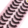 Plateau en plastique rose contenant plusieurs paires de faux cils de renard noirs.