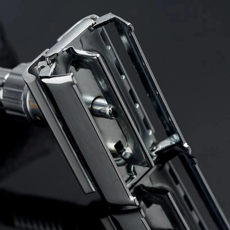 Close-up view of a silver double edge safety razor with a butterfly opening mechanism.
