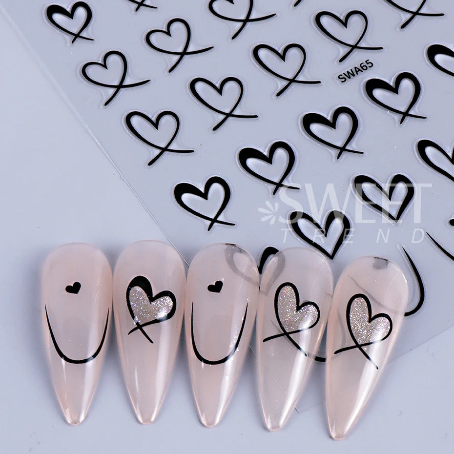 Un ensemble de décals de cœurs d'amour en nail 3D pour manucure DIY, présenté sur une surface blanche.