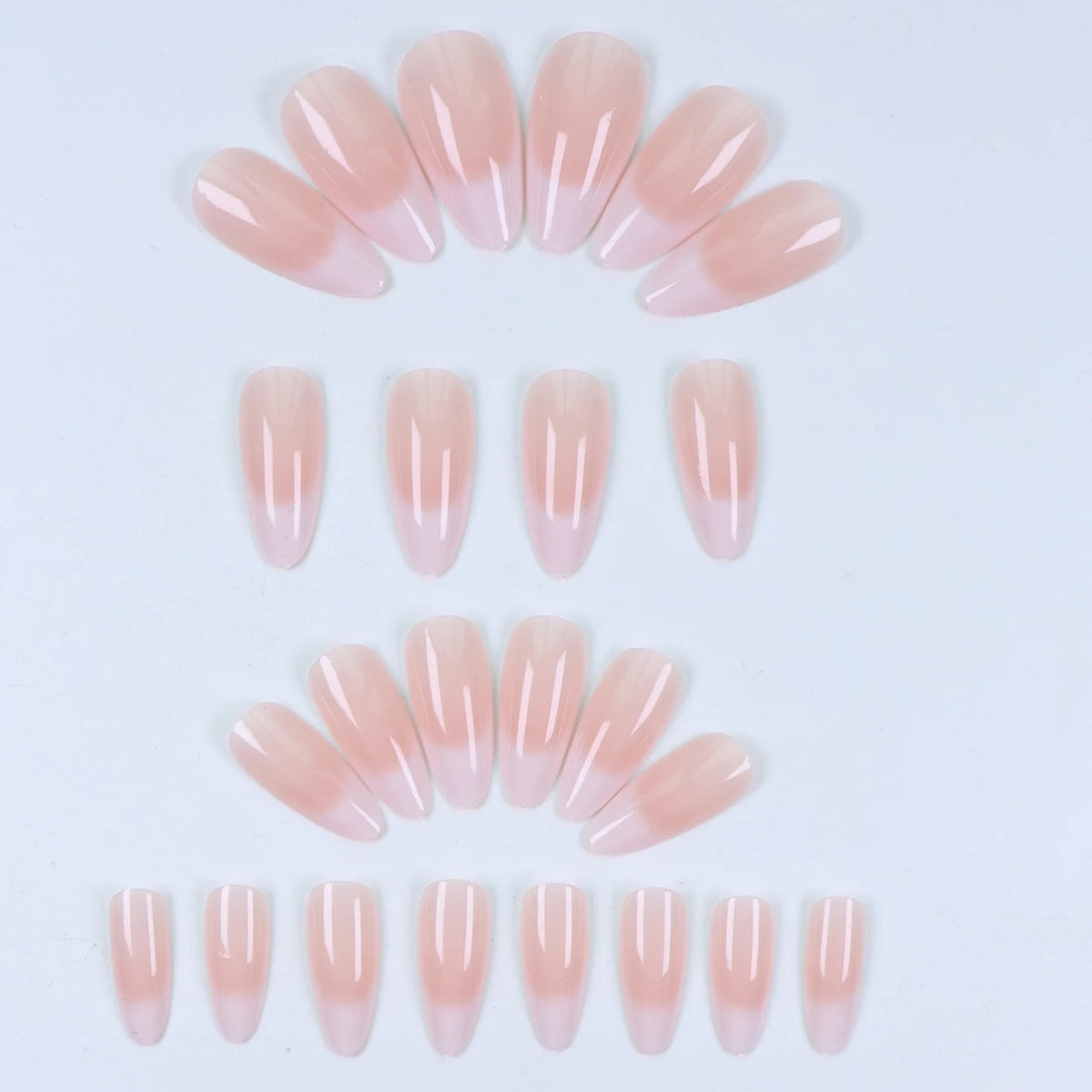 A set of 24 almond press-on nails with a pink bow design in various shades of pink and nude.