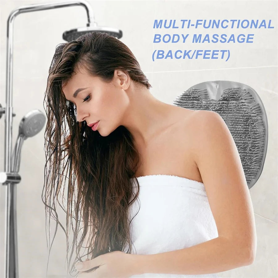A woman is using a multi-functional body massage tool on her back or feet in a shower setting.