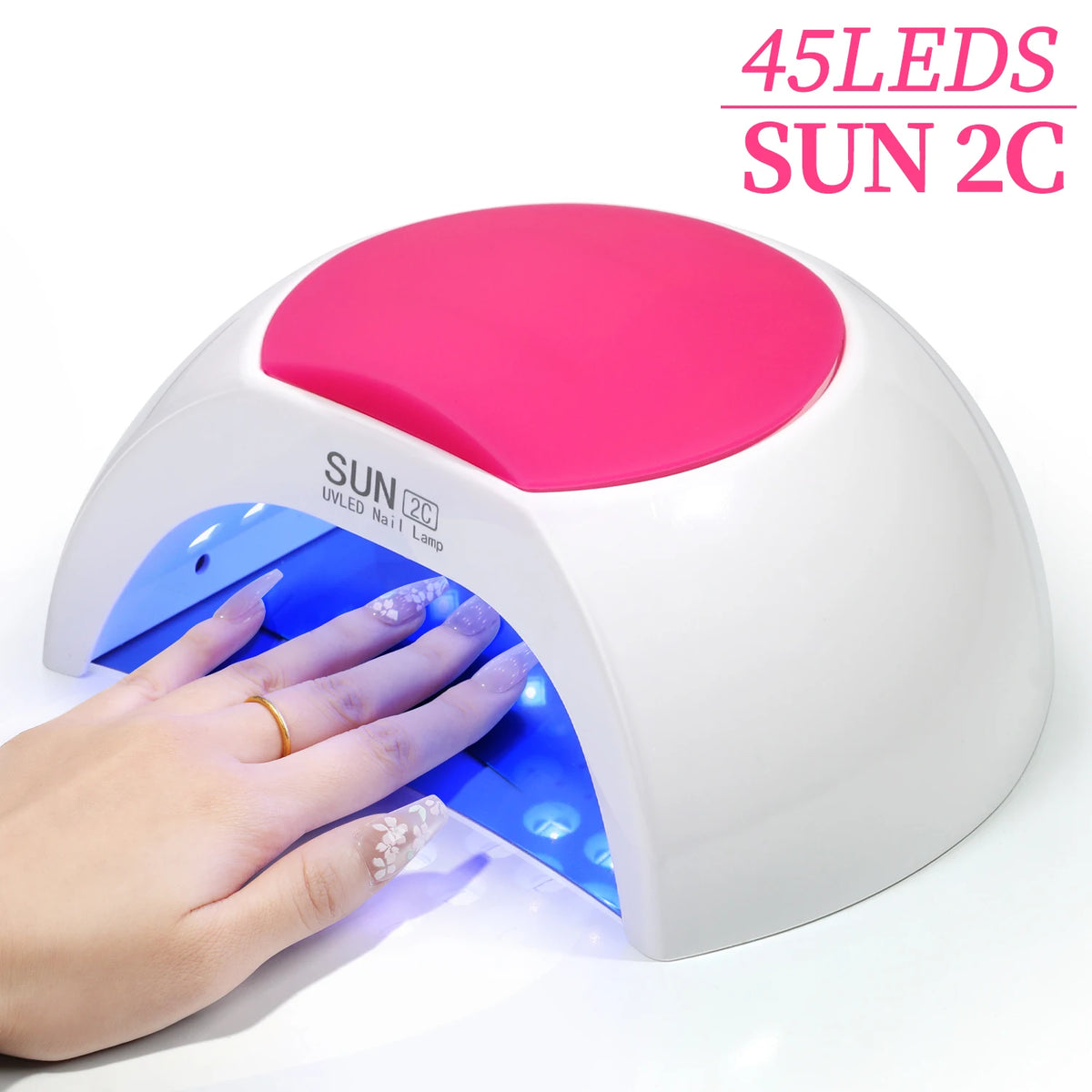 Une main tient une lampe à ongles UV LED blanche avec une lumière rose émanant du haut, illuminant la lumière bleue en dessou