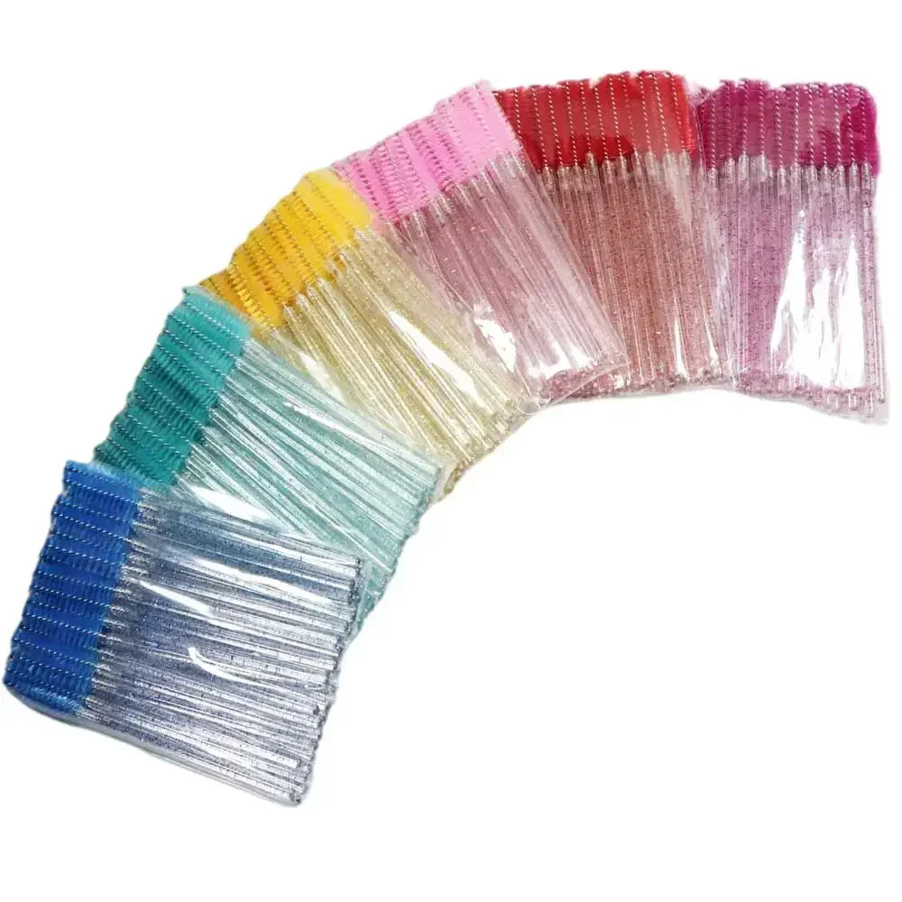 A set of disposable eyelash and eyebrow brushes in various shades of pink, yellow, green, and blue.