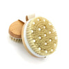A natural dry brushing body scrub brush with wooden handles and light blonde bristles.