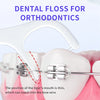 Dental floss is shown being used on a tooth with braces to clean around the wire.