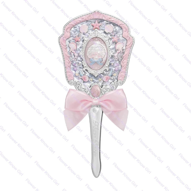 A pink pearl hand mirror with a decorative frame and a silver handle for makeup and beauty.