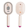 A pink electric retractable hair smoothing brush with a gray control and orange hair smoothing bristles.
