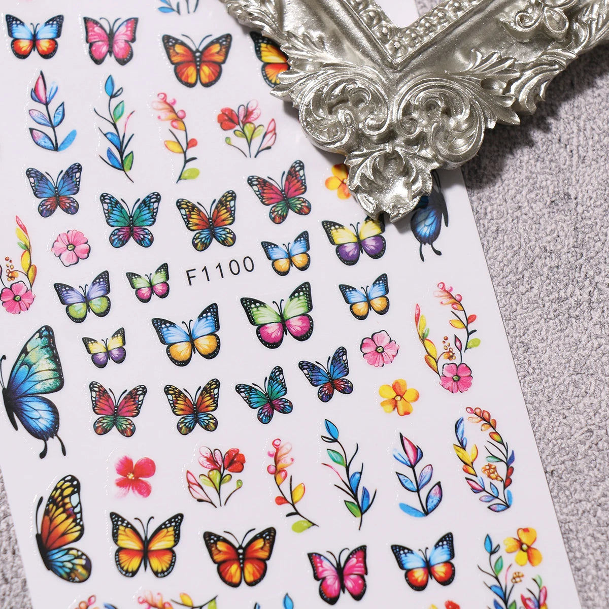 A collection of colorful flower and butterfly nail stickers for DIY decoration