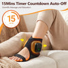 A person is using a black heated ankle massager device on their foot while relaxing indoors.