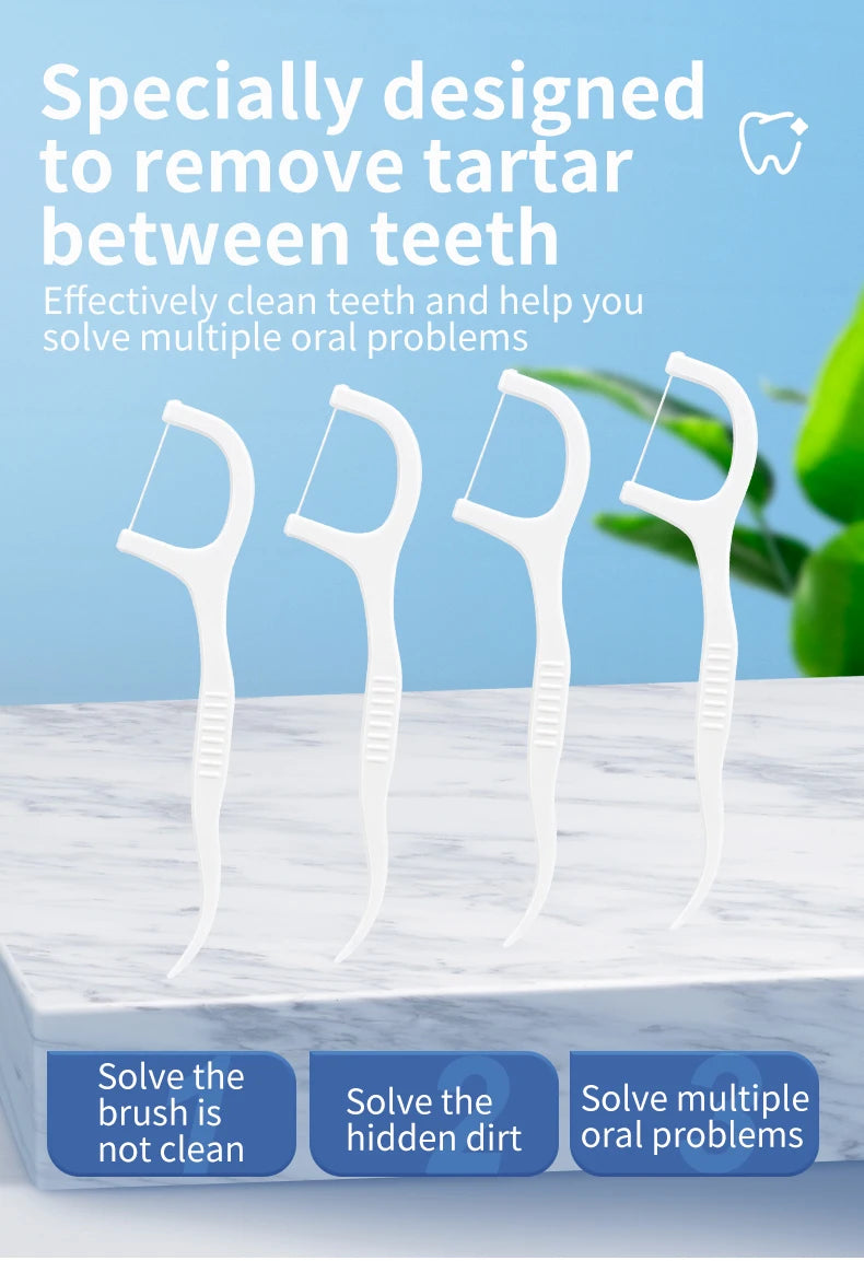 Fil dentaire blanc conçu pour enlever le tartre entre les dents, montré sur une surface de marbre.