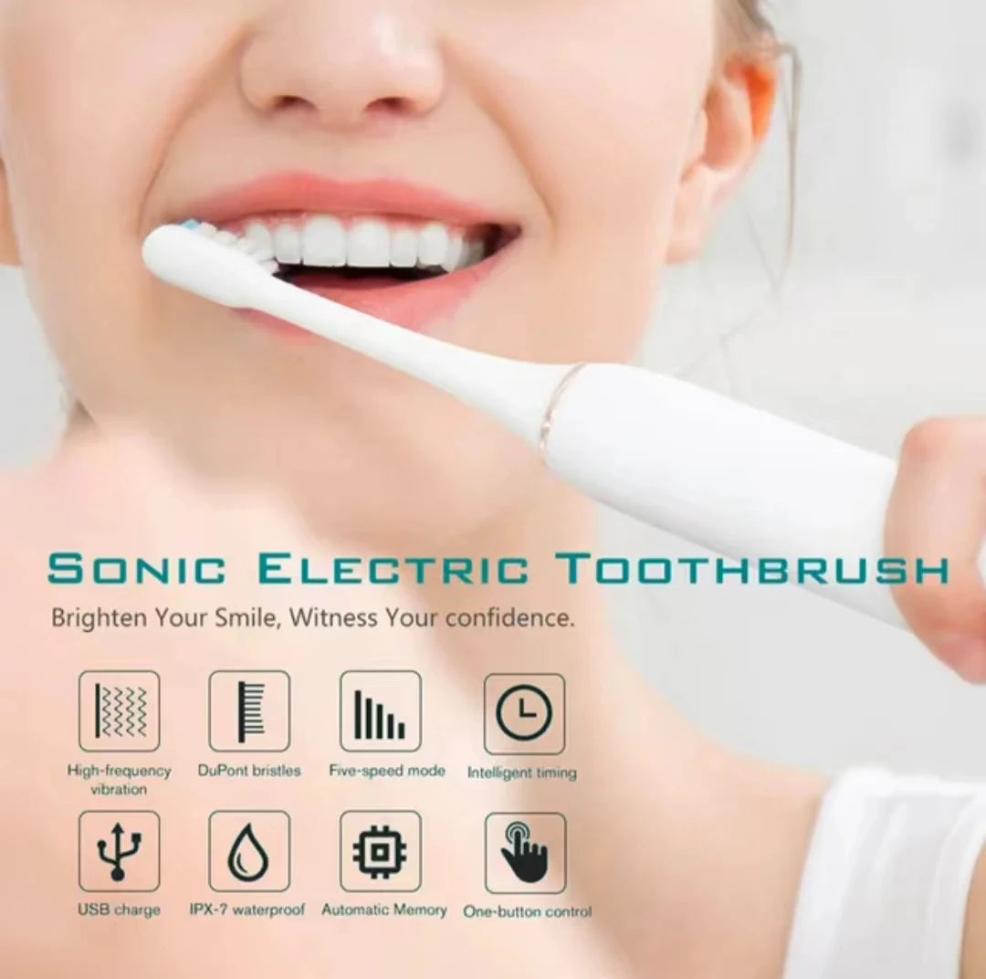 A close-up of a woman using a white sonic electric toothbrush for oral cleaning.