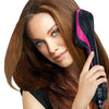 A woman is using a pink and black professional hair dryer brush and curling comb on her brown hair.