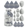 A collection of 15 makeup sponges in various shapes and shades, including a glass jar for storage.