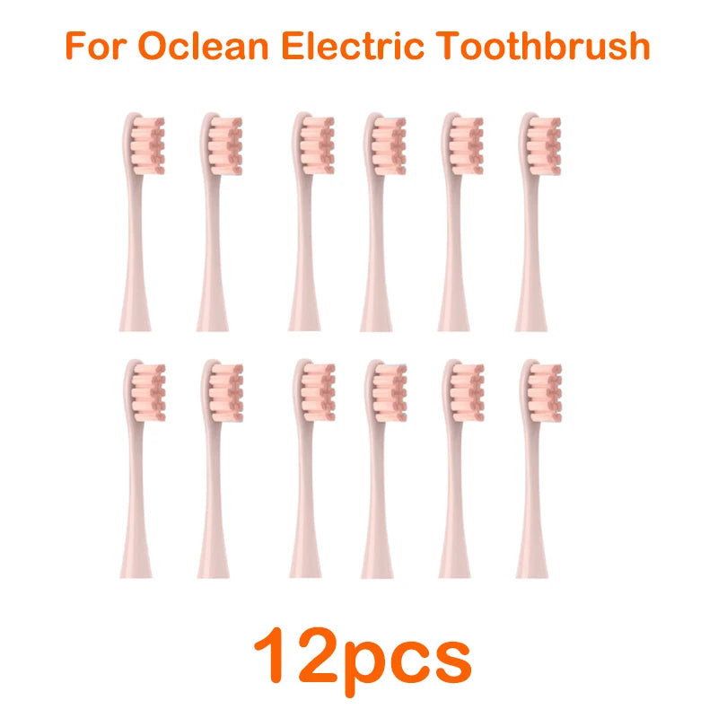 Twelve replacement brush heads for an Ocean electric toothbrush, shown in various pink colors.
