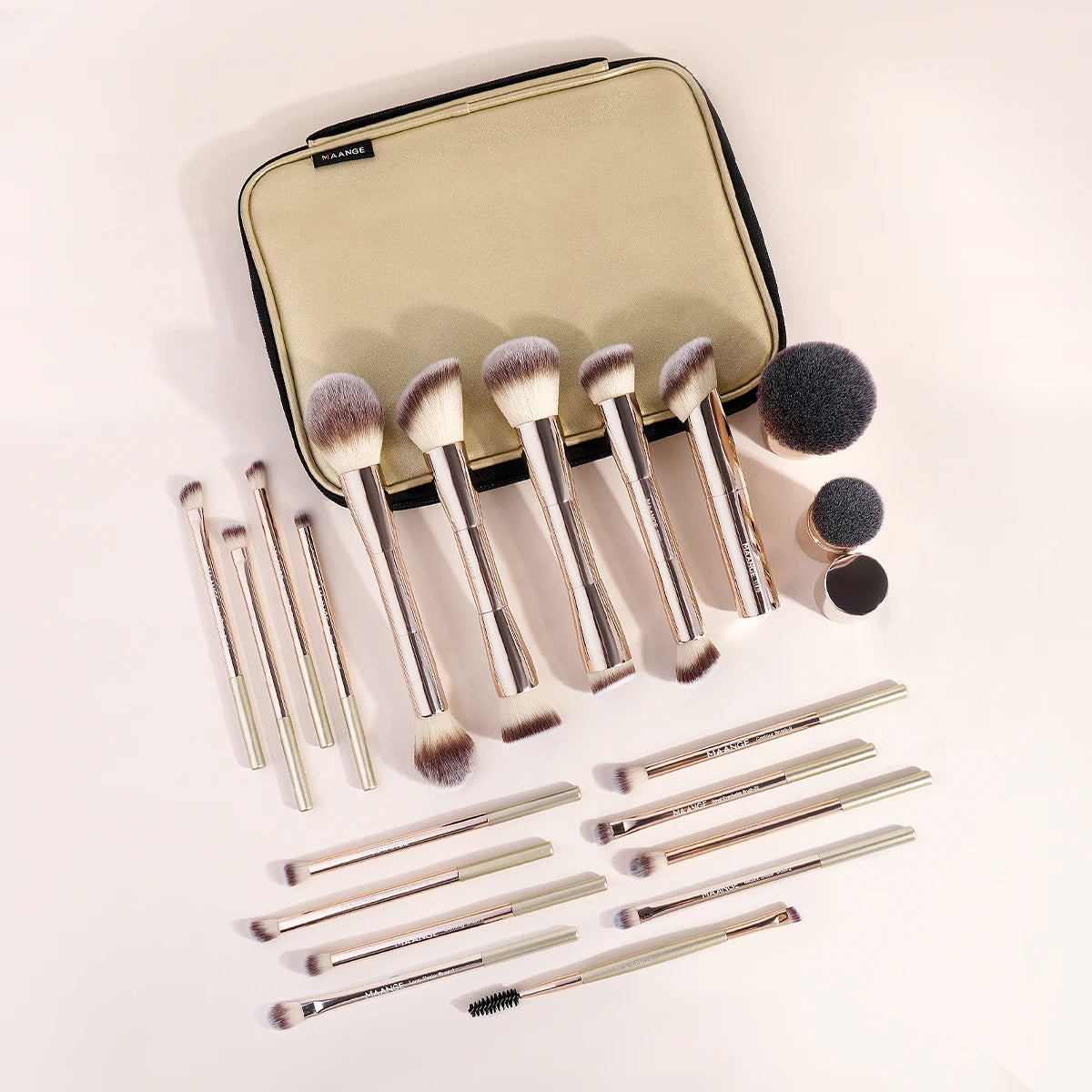 A set of twenty professional makeup brushes with a gold handle and soft bristles displayed next to a black travel case.