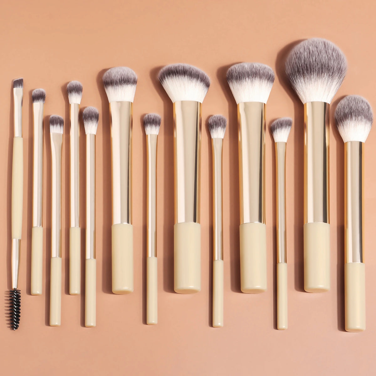A collection of thirteen professional makeup brushes with varying sizes and styles displayed on a neutral background.