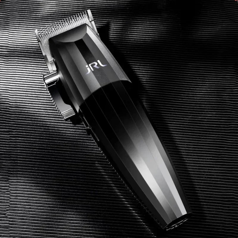 A black professional electric hair trimmer kit lying on a dark textured surface.