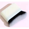 A white makeup brush with black and white synthetic bristles shown against a light background.