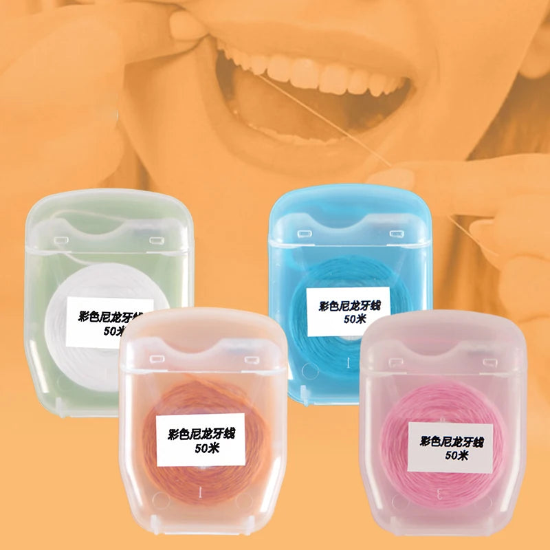 Three containers of 50m disposable nylon dental floss in green, blue, and pink.