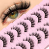 A close-up of a pink lash tray with black wispy cat eye false mink eyelashes displayed on the surface.