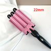 A pink professional triple barrel ceramic hair curling iron with a black handle, shown against a white background.