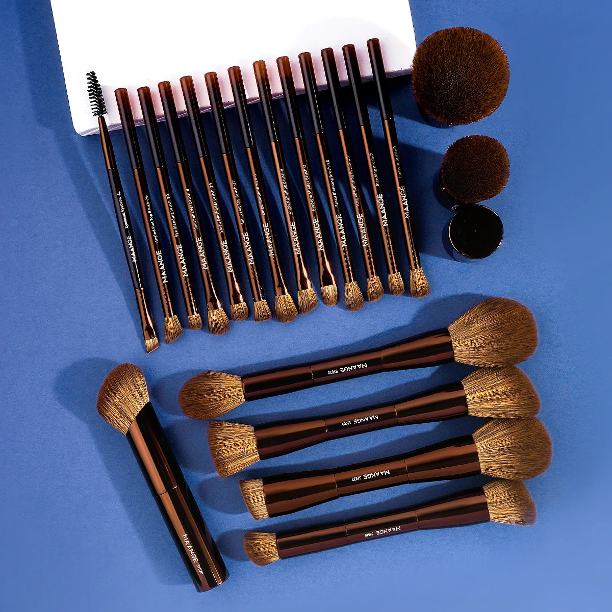 A set of professional makeup brushes in various sizes and shades for foundation and eyeshadow application.