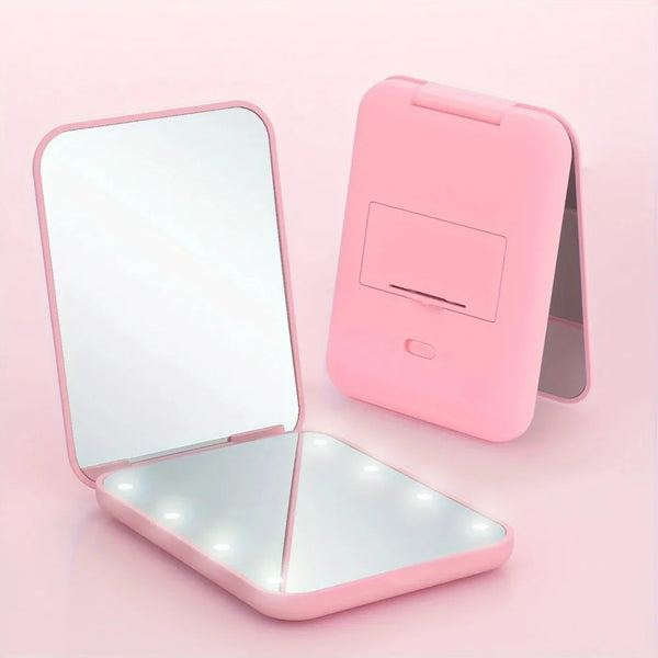 A pink mini folding makeup mirror with an LED light, shown open and closed.