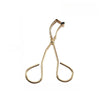 A gold-toned mini stainless steel eyelash curler with a black jewel tip.