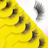 A close-up of yellow false eyelash pads with several pairs of wispy black lashes displayed on a white background.