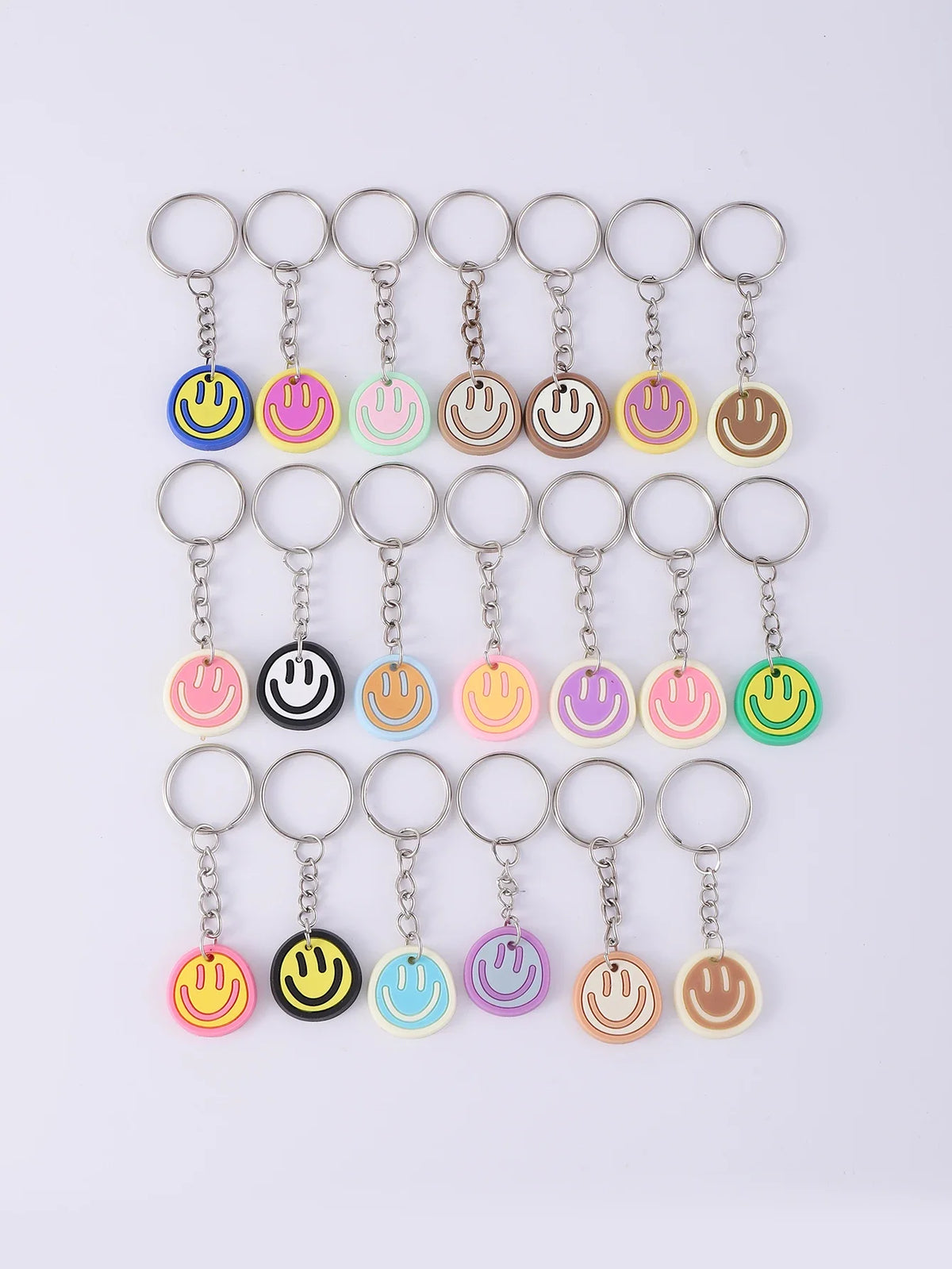 A set of 20 colorful cartoon smile face keychains hanging from split rings.