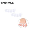 A pair of white silicone toe separators shown next to a foot for bunion relief.