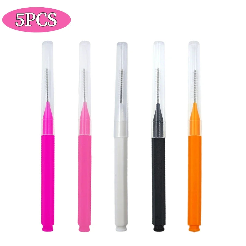 A set of five mini brow and eyelash combs in pink, white, black, and orange colors.