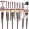 A collection of various makeup brushes with synthetic hair in shades of brown and pink.