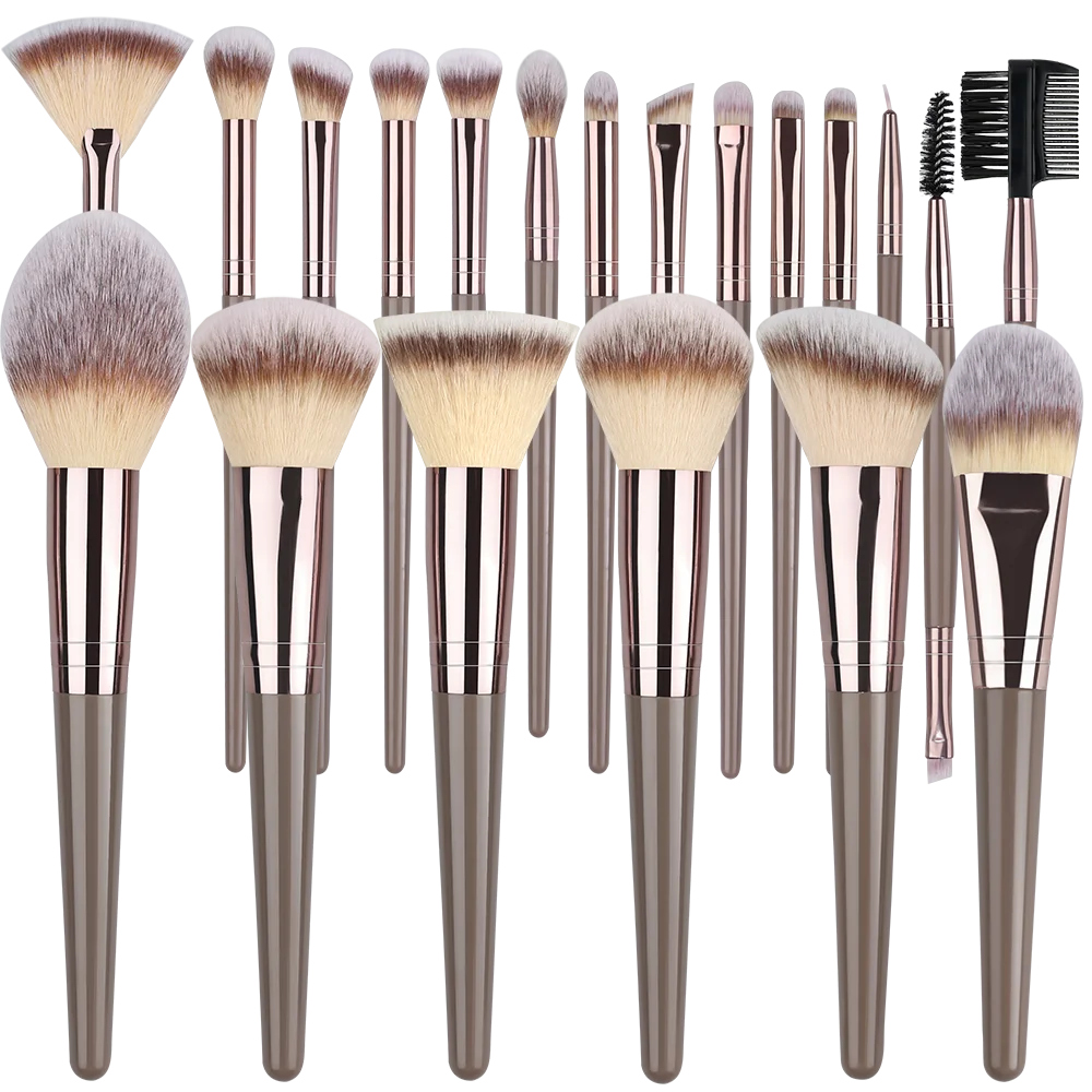 A collection of various makeup brushes with synthetic hair in shades of brown and pink.