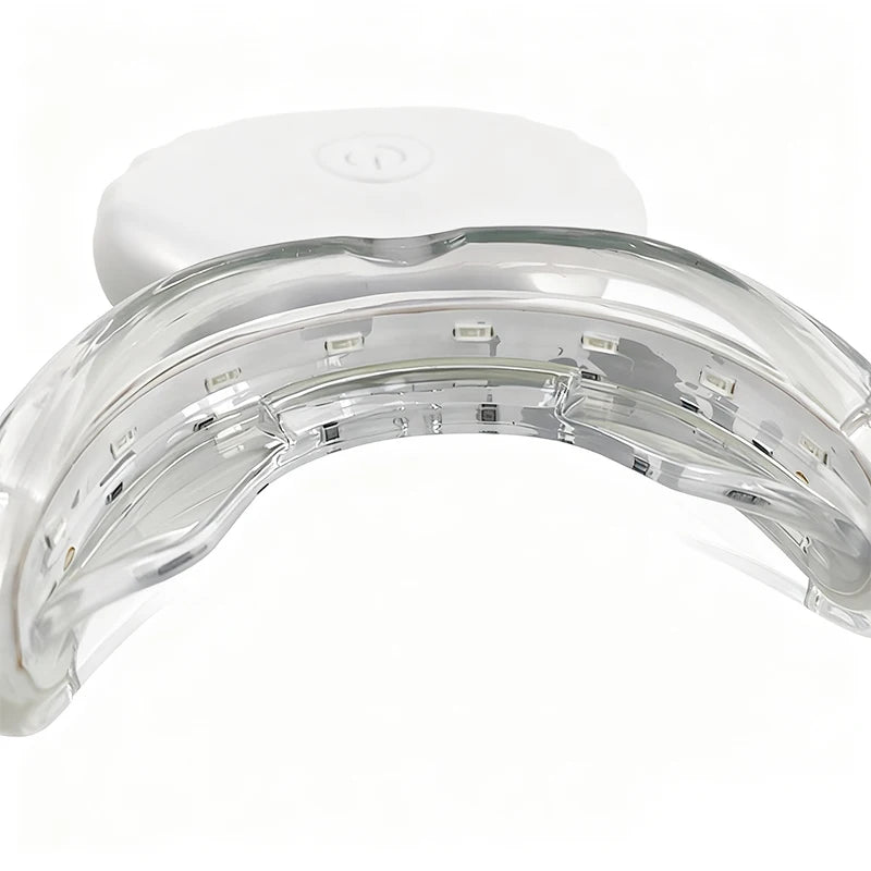 A clear, U-shaped dental whitening tray with a white plastic base and internal light elements.