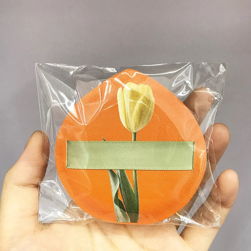 An orange air cushion makeup puff set with a yellow rose is visible inside a clear plastic storage box.