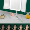 A foldable LED makeup mirror with magnification is displayed on a white surface, showing brightness levels from 300LUX to 900