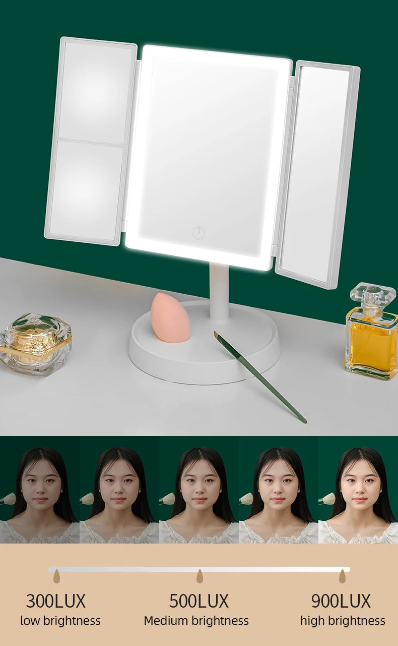 A foldable LED makeup mirror with magnification is displayed on a white surface, showing brightness levels from 300LUX to 900