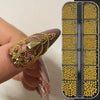 A hand holds a gold mixed stainless steel bead nail art decoration set with various colored beads in an acrylic case.