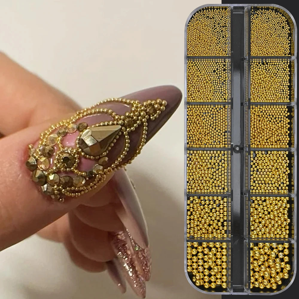 A hand holds a gold mixed stainless steel bead nail art decoration set with various colored beads in an acrylic case.
