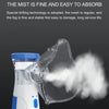 A clear plastic nebulizer device is shown emitting a fine white mist.