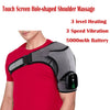 A person is using a black shoulder massager on their red shirt, demonstrating the device's application.