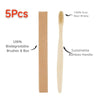 Five pieces of eco-friendly bamboo toothbrushes with natural bristles and boxes shown side by side.