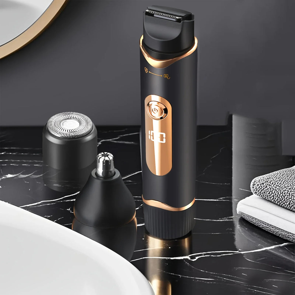 A black electric body hair trimmer with a gold accent is shown on a dark marble surface.