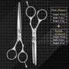 A set of flat shears and tooth scissors in silver metal on a dark background.