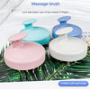 Three silicone massage brushes in pink, light blue, and purple are shown on a green leaf background.